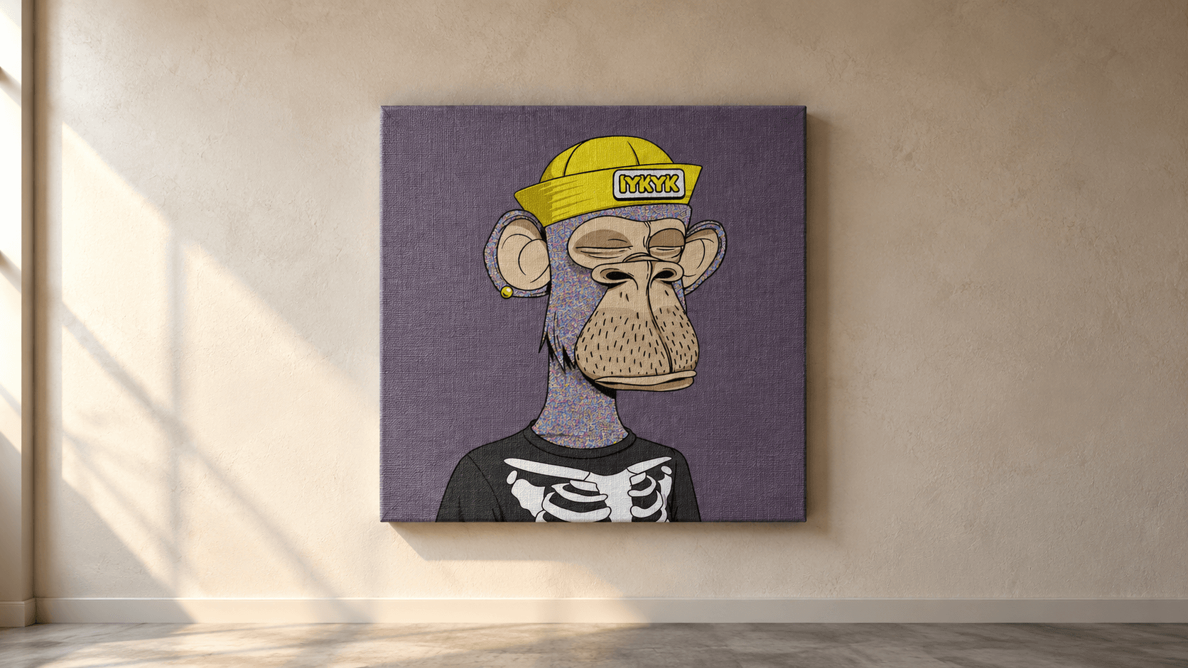 An ape NFT printed on a large textured canvas and hanging on a sunlit plaster wall